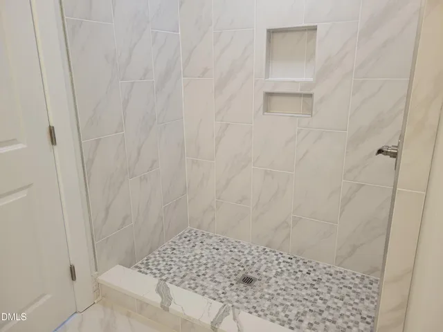 a bathroom with a toilet sink vanity and mirror