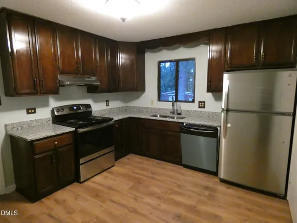 a kitchen with a sink appliances and cabinets