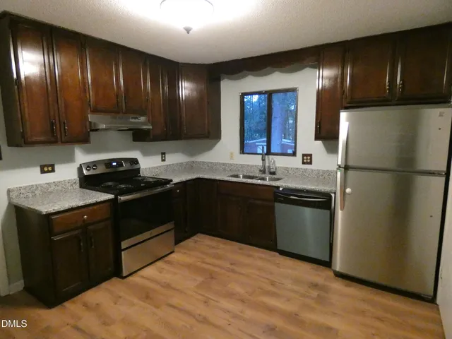 a kitchen with a sink appliances and cabinets