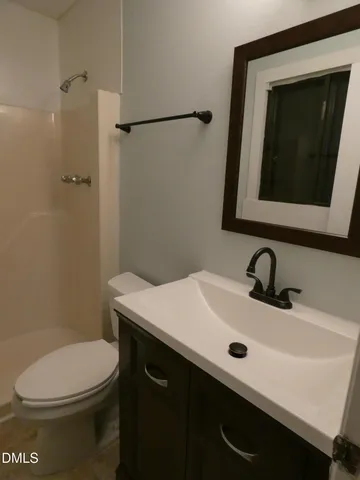 a bathroom with a sink a toilet and mirror