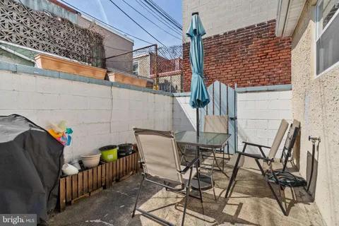 a view of a patio with couple of chairs
