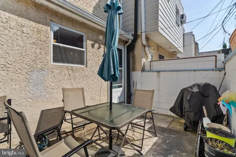 a view of a chairs and a table in the balcony