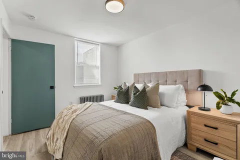 a bedroom with a bed and window
