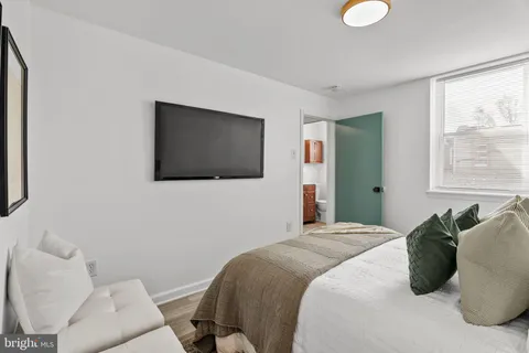 a bedroom with a bed and a flat screen tv