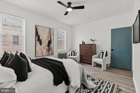 a bedroom with a bed and wooden floor