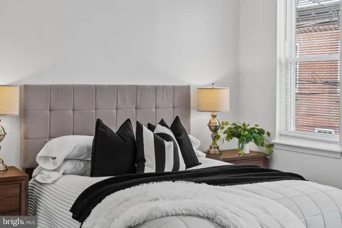 a bedroom with a bed and a potted plant