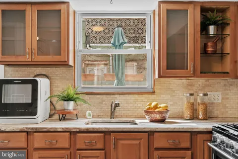 a kitchen with granite countertop a sink and a stove