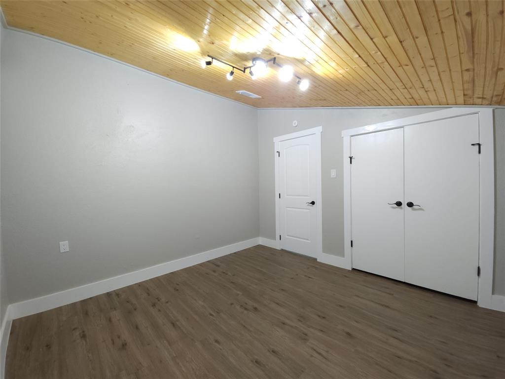 7039 Bates Street Dallas, TX 75227 - Photo 23 of 40 a view of room with wooden floor