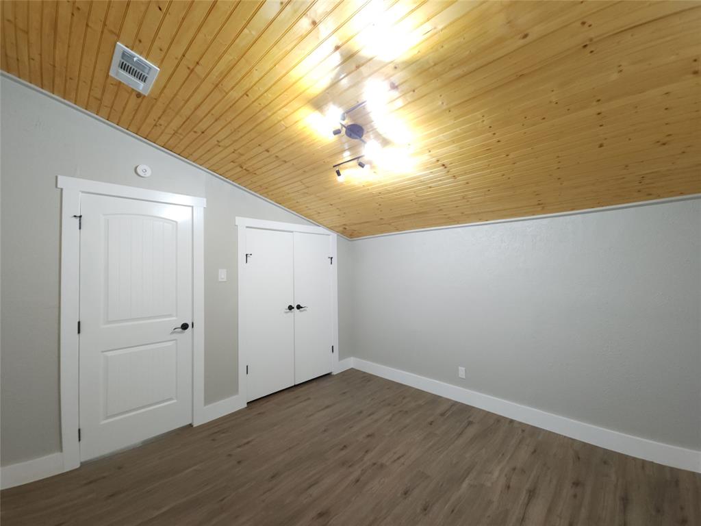 7039 Bates Street Dallas, TX 75227 - Photo 25 of 40 a view of a room with wooden floor