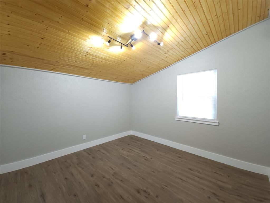 7039 Bates Street Dallas, TX 75227 - Photo 26 of 40 a view of empty room with wooden floor