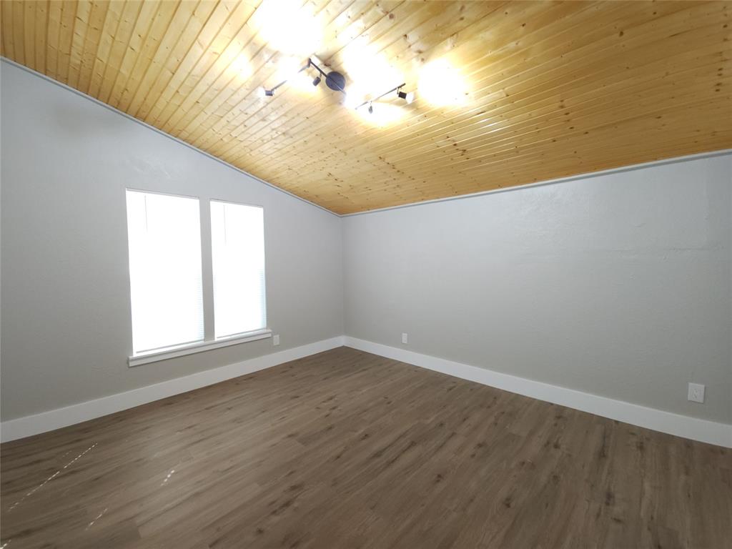 7039 Bates Street Dallas, TX 75227 - Photo 28 of 40 a view of empty room with wooden floor and fan
