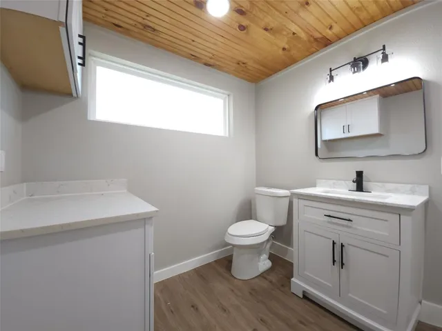 a bathroom with a sink toilet and mirror