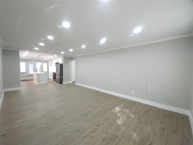 an empty room with a kitchen