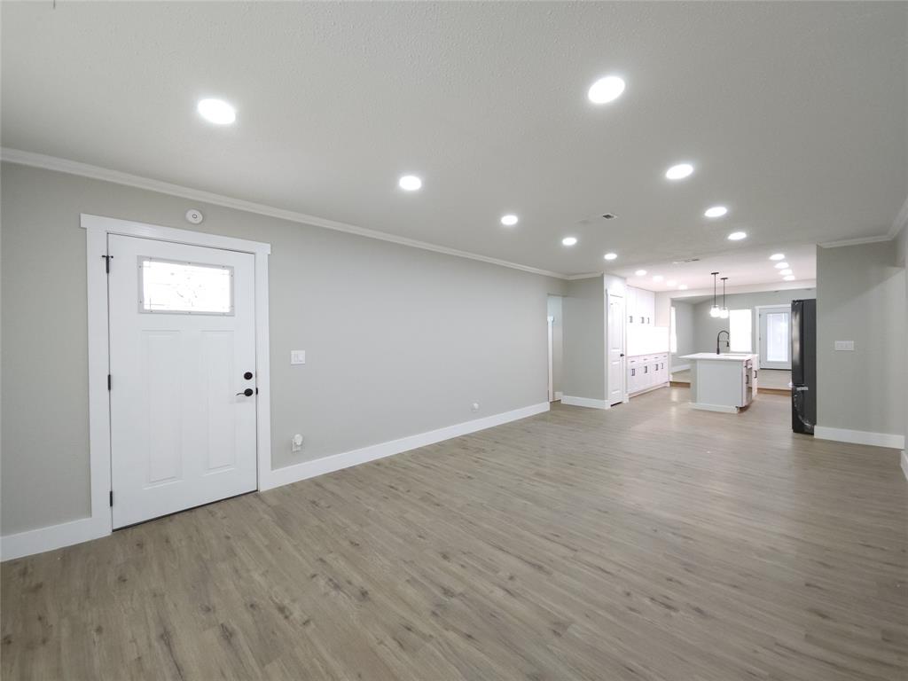 7039 Bates Street Dallas, TX 75227 - Photo 5 of 40 a view of empty room with wooden floor