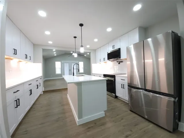 a kitchen with refrigerator and window