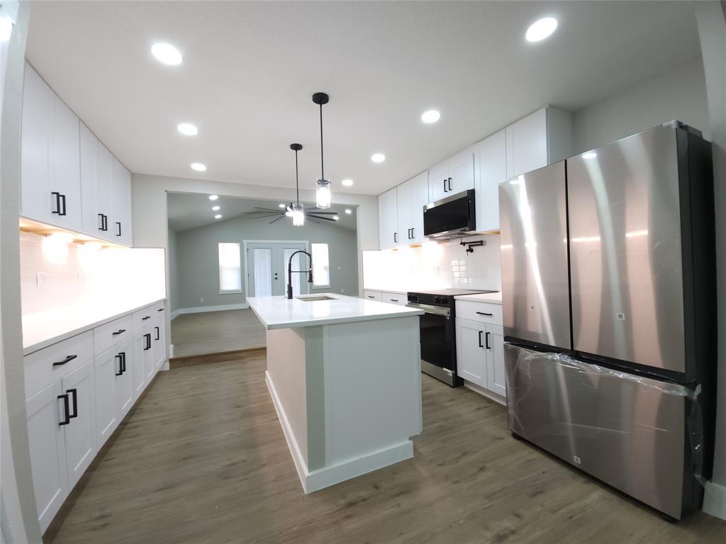 7039 Bates Street Dallas, TX 75227 - Photo 7 of 40 a kitchen with refrigerator and window