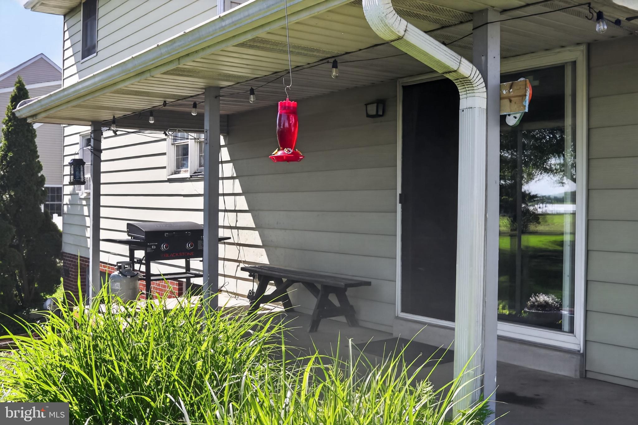 1106 Village Road Lancaster, PA 17602 - Photo 33 of 42 Charming porch with vibrant greenery.