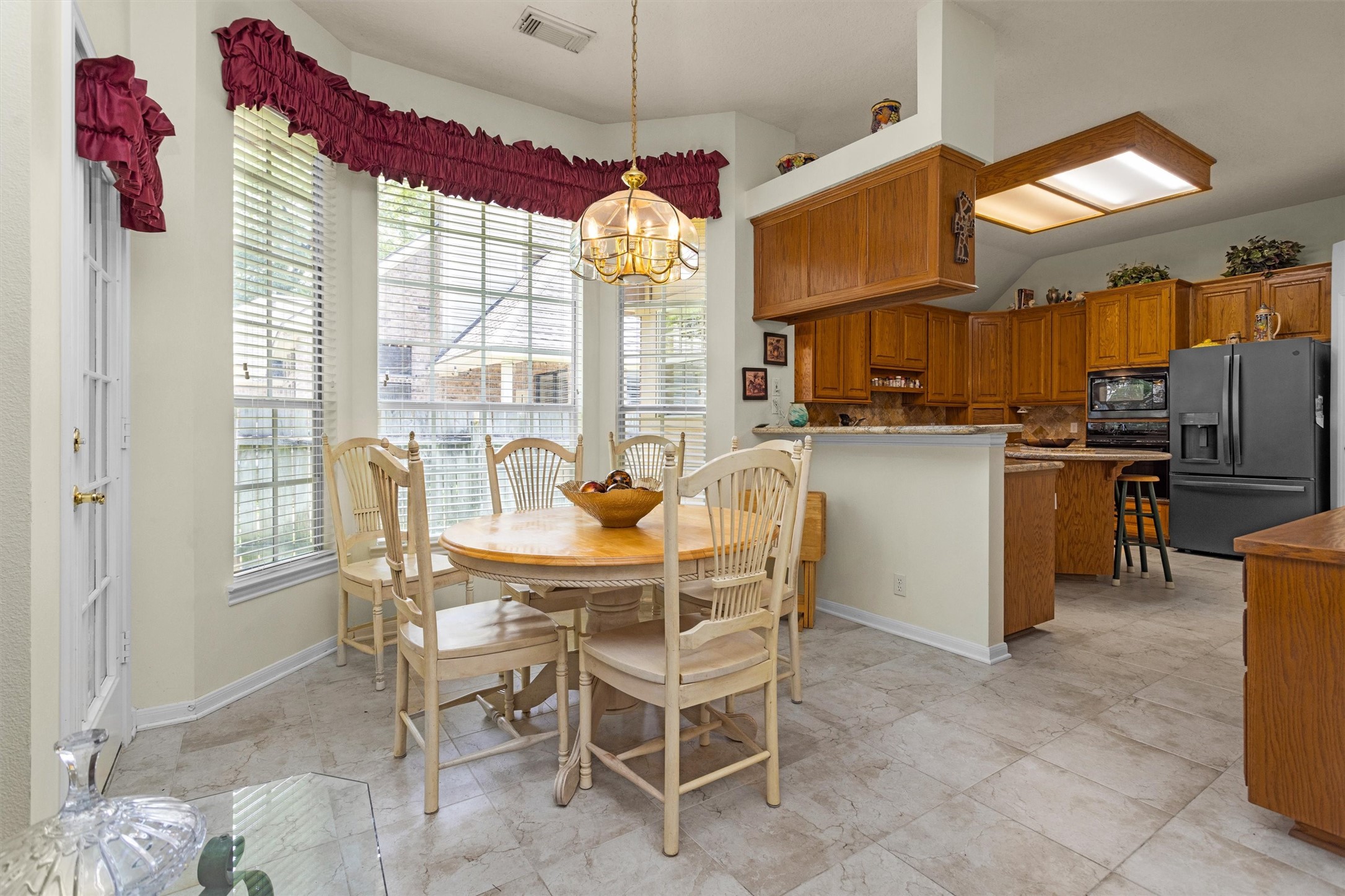 529 Stephen F Austin Drive Conroe, TX 77302 - Photo 18 of 37 a dining room with furniture a chandelier and kitchen view
