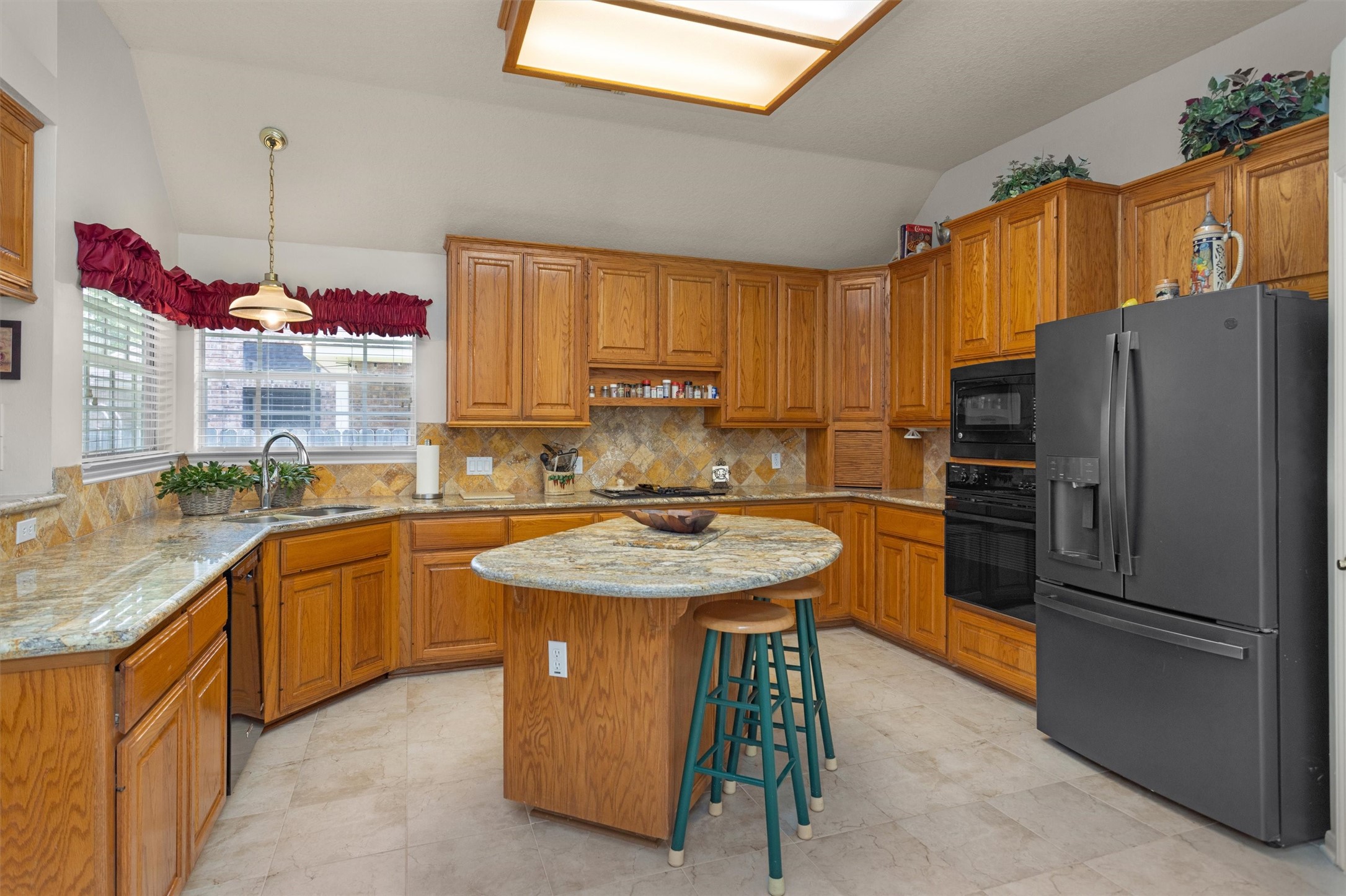 529 Stephen F Austin Drive Conroe, TX 77302 - Photo 21 of 37 a kitchen with stainless steel appliances granite countertop a sink stove and refrigerator