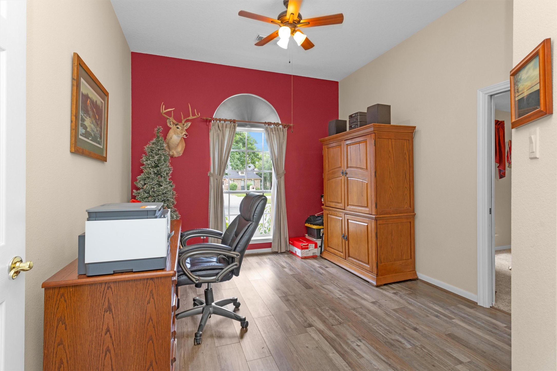 529 Stephen F Austin Drive Conroe, TX 77302 - Photo 22 of 37 a view of workspace with wooden floor windows ceiling fan and windows