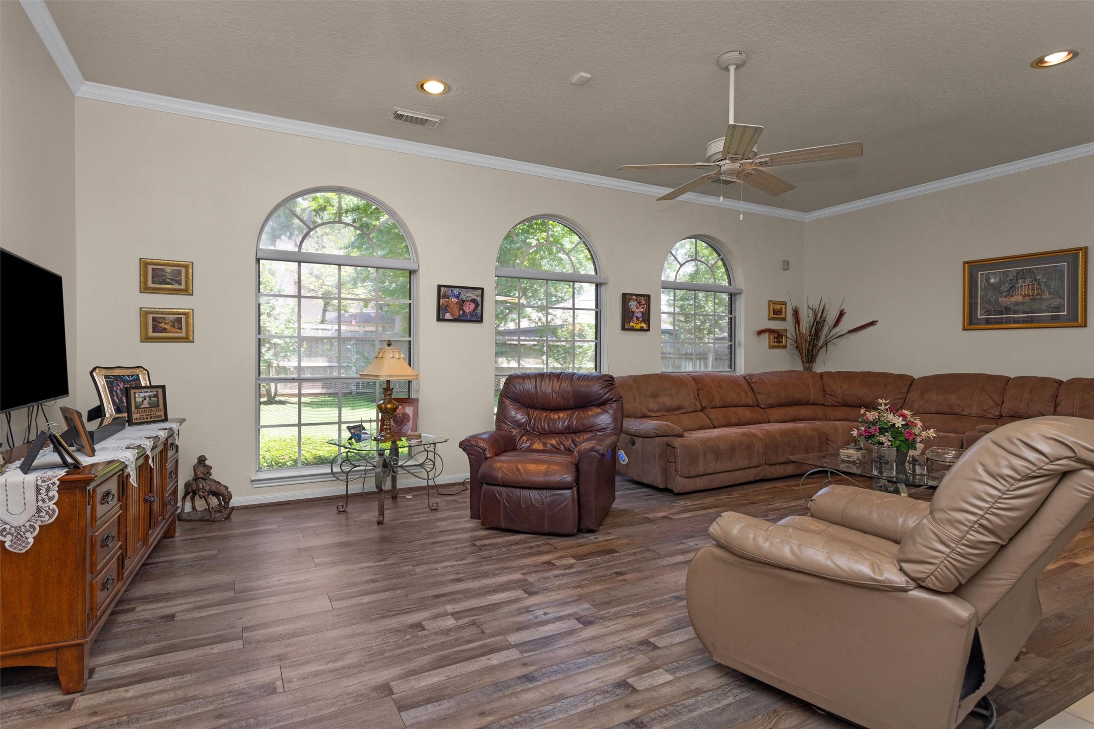 529 Stephen F Austin Drive Conroe, TX 77302 - Photo 25 of 37 a living room with furniture a chandelier and a large window