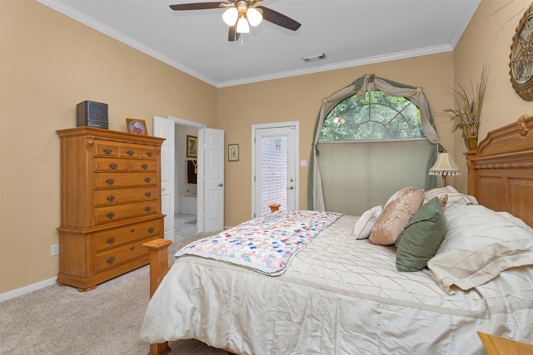 529 Stephen F Austin Drive Conroe, TX 77302 - Photo 28 of 37 a bedroom with a bed and a dresser