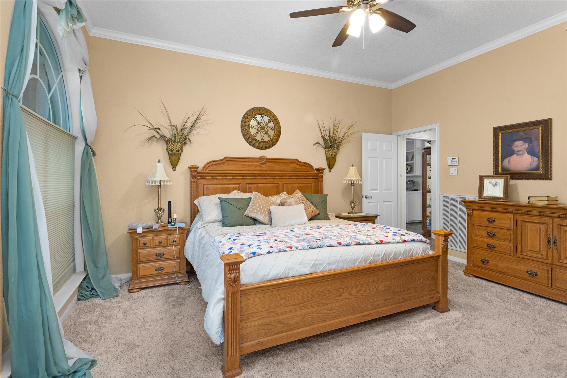 529 Stephen F Austin Drive Conroe, TX 77302 - Photo 29 of 37 a bedroom with a bed and a chandelier