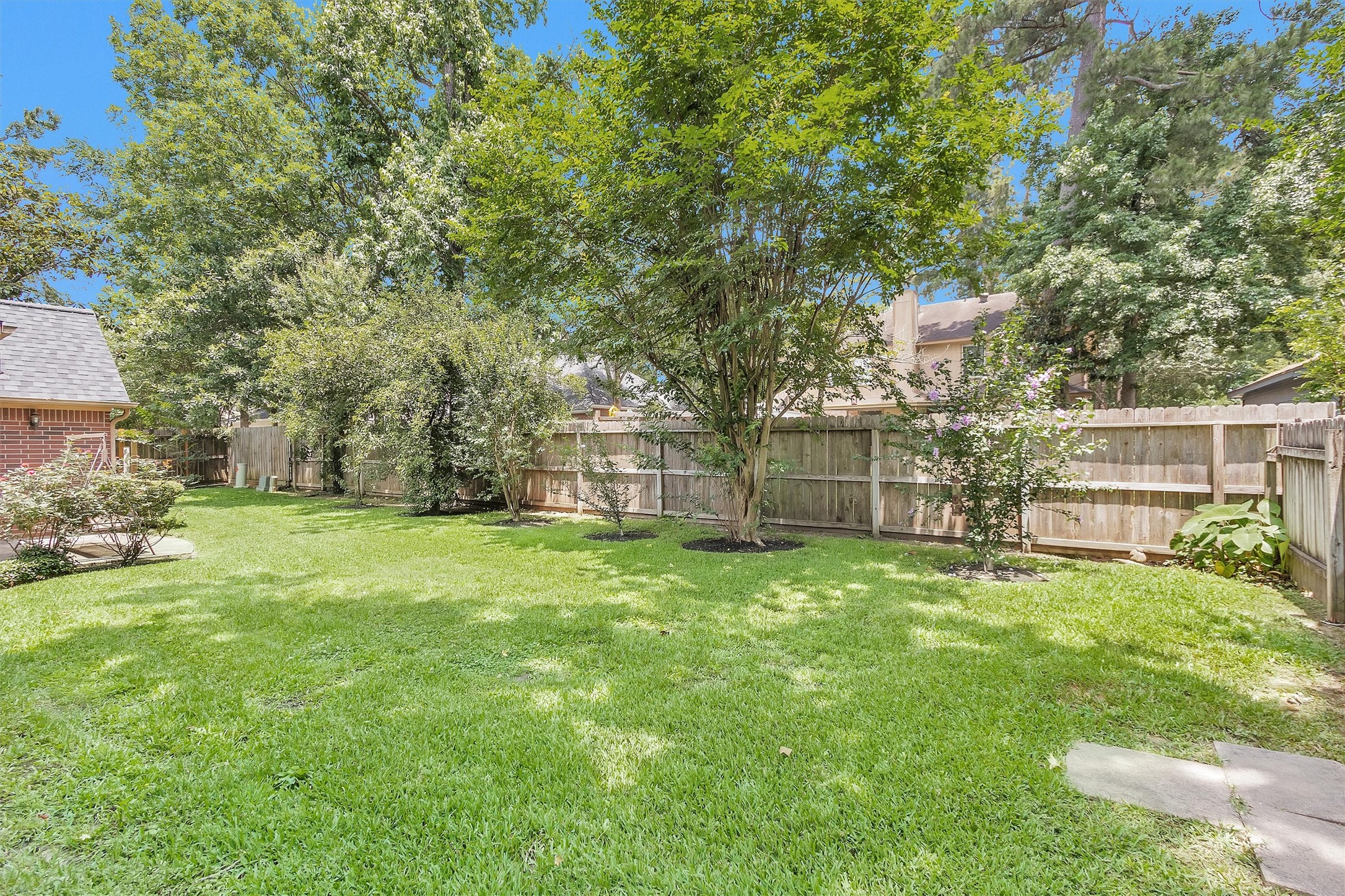 529 Stephen F Austin Drive Conroe, TX 77302 - Photo 35 of 37 a view of a yard with a house and a large tree