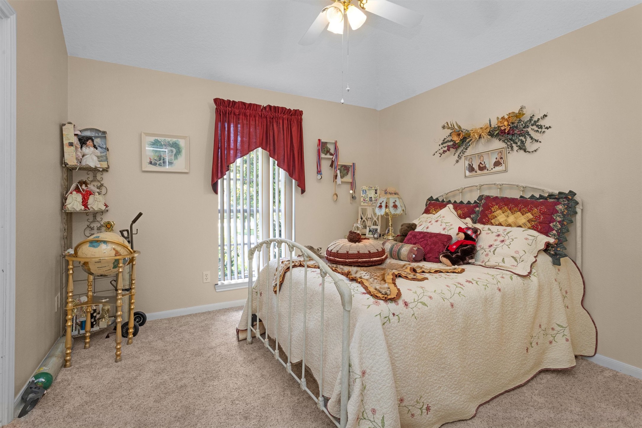 529 Stephen F Austin Drive Conroe, TX 77302 - Photo 36 of 37 a bedroom with a bed and a chandelier