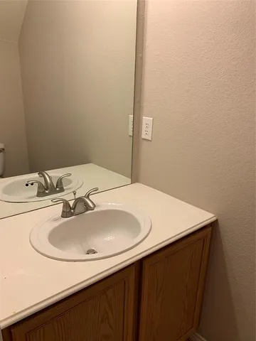 a white toilet sitting next to a bath tub