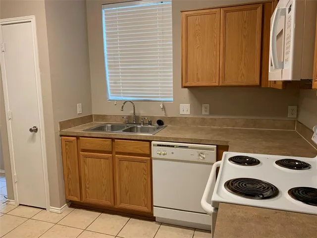 a kitchen with a sink a stove and cabinets
