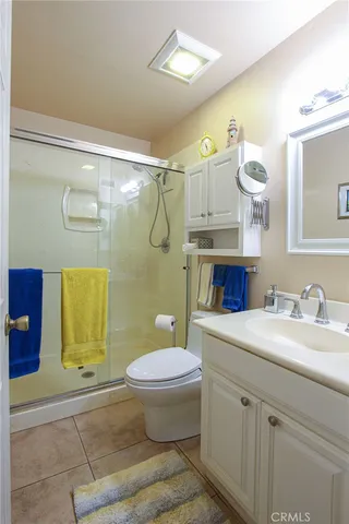 a bedroom with double bed and a potted plant