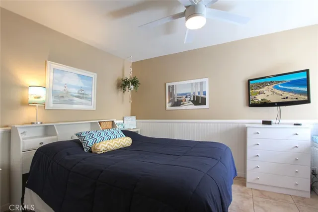 a bedroom with a bed and a painting on the wall