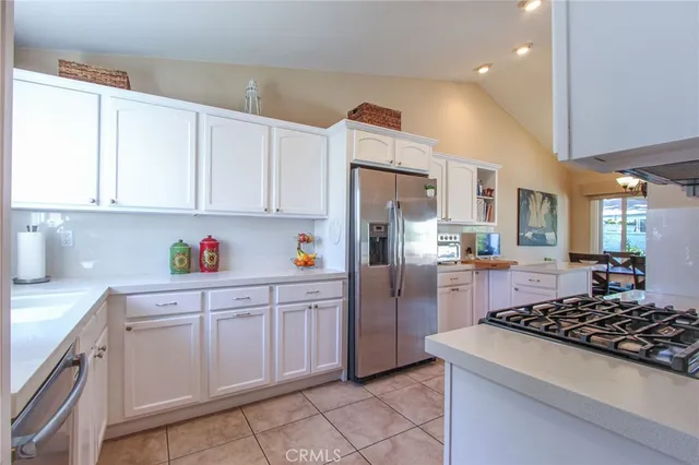a kitchen with stainless steel appliances granite countertop a stove a refrigerator and a microwave