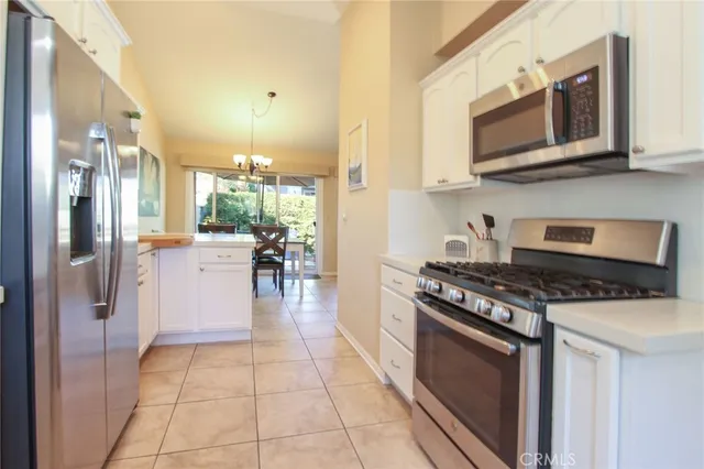 a kitchen with stainless steel appliances granite countertop a sink and cabinets