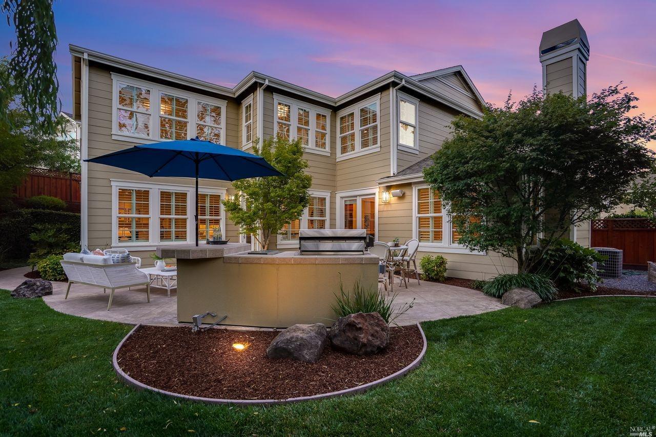 a view of a house with a swimming pool and a yard
