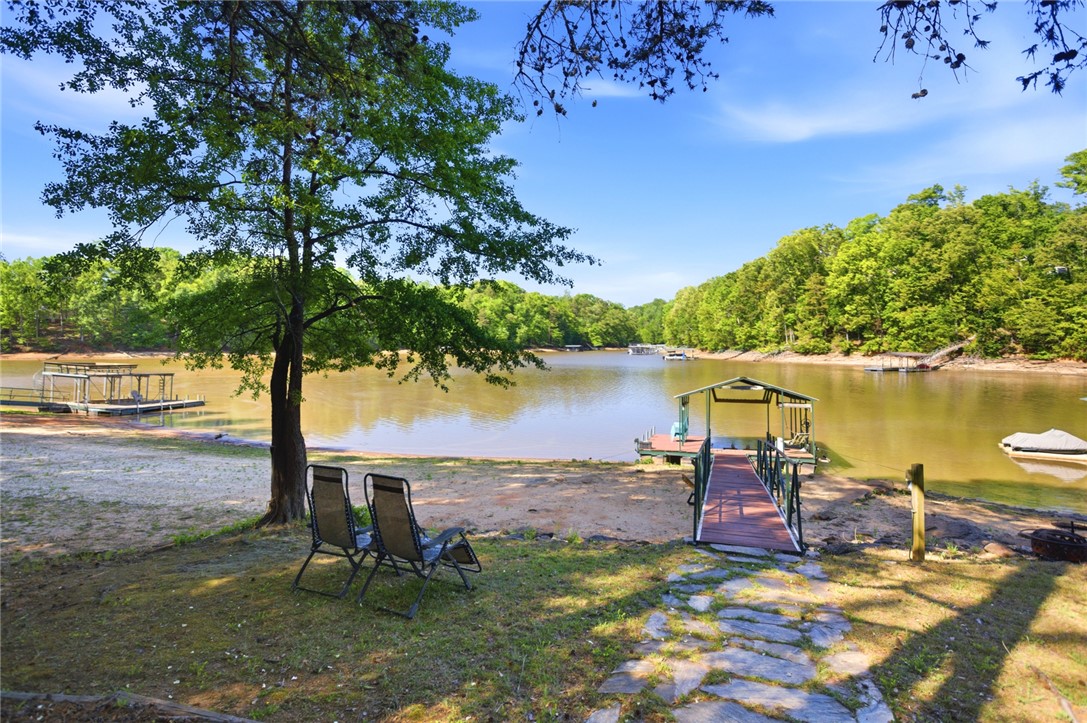 110 Snug Harbor Road Seneca, SC 29678 - Photo 30 of 37 This serene lakeside property offers direct access to the water with a private boat dock.