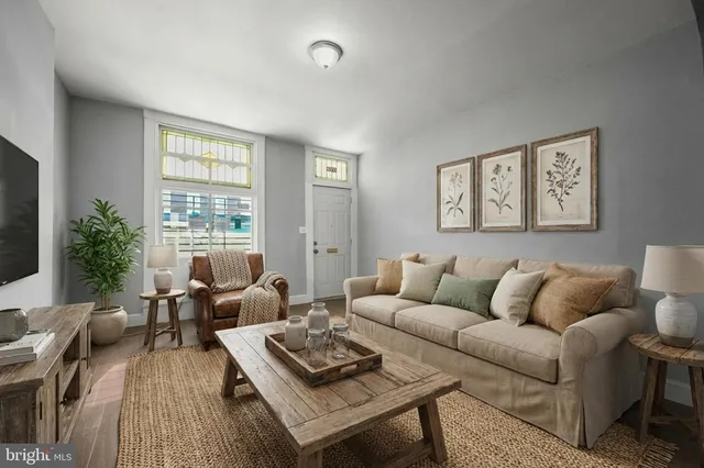 a living room with furniture rug and window