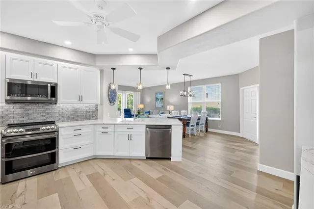 a kitchen with a stove a sink and a microwave