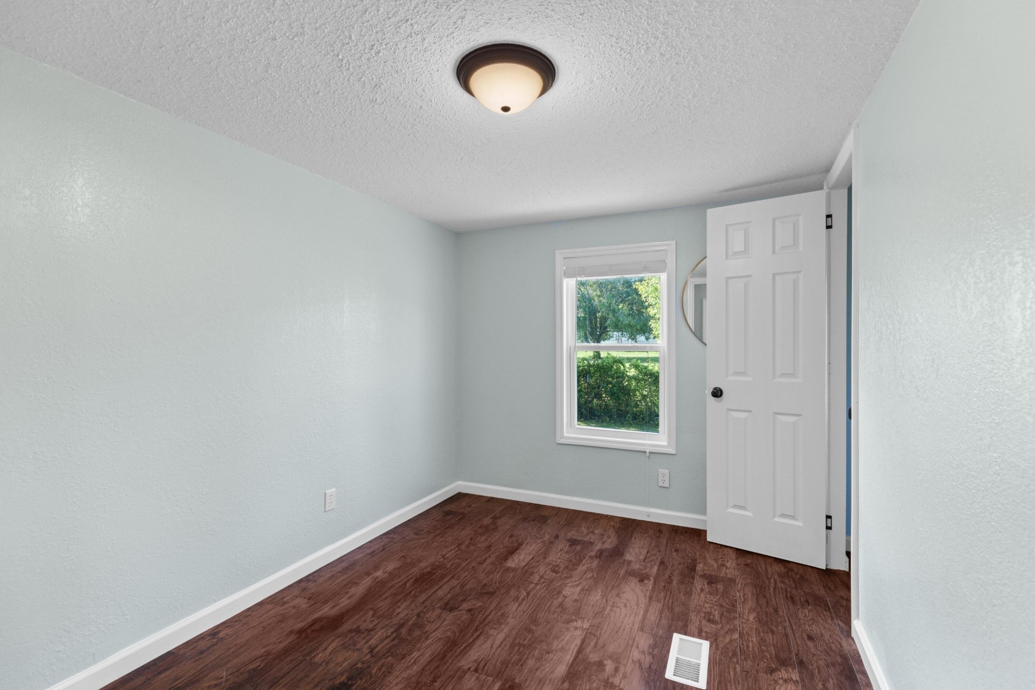 309 Rhodes Road New Market, TN 37820 - Photo 13 of 30 an empty room with wooden floor and windows