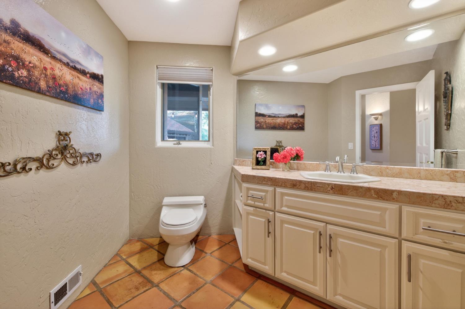 7570 Airola Road Vallecito, CA 95251 - Photo 79 of 90 a bathroom with a toilet sink and mirror