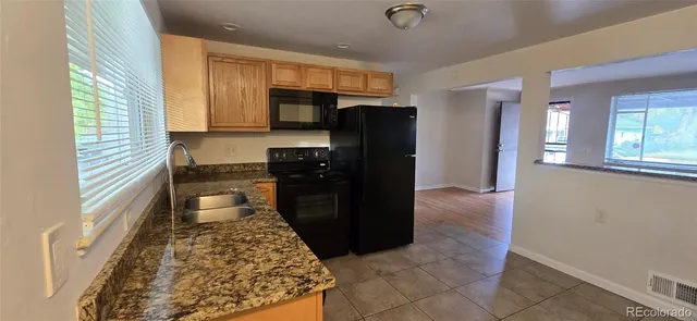 a kitchen with a refrigerator and a stove