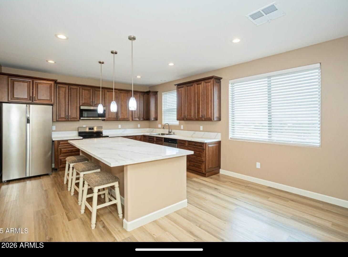4695 Kerry Drive Rimrock, AZ 86335 - Photo 20 of 47 a kitchen with kitchen island granite countertop wooden cabinets a refrigerator a stove a sink and a oven