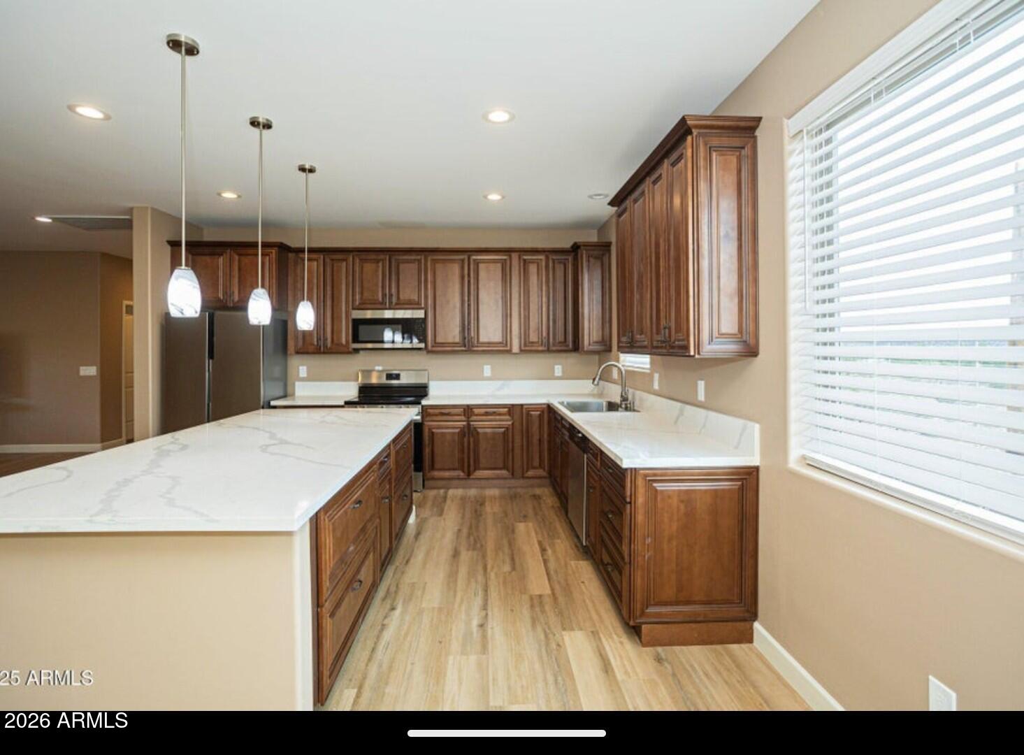 4695 Kerry Drive Rimrock, AZ 86335 - Photo 22 of 47 a kitchen with kitchen island granite countertop wooden cabinets a sink and a stove