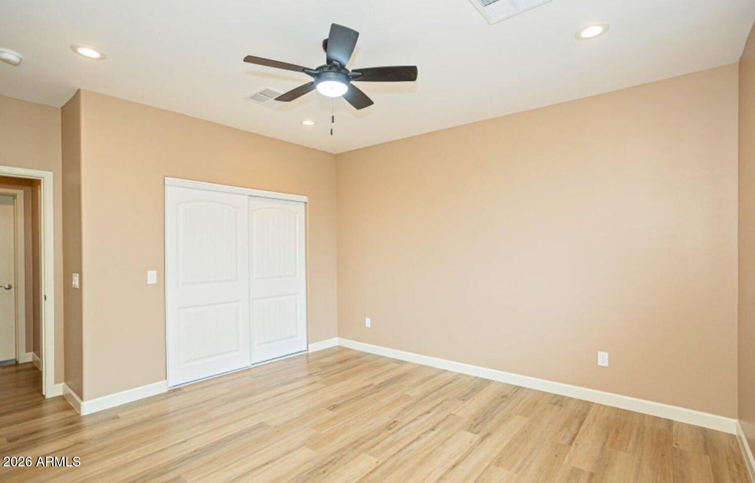 4695 Kerry Drive Rimrock, AZ 86335 - Photo 29 of 47 an empty room with wooden floor and a ceiling fan