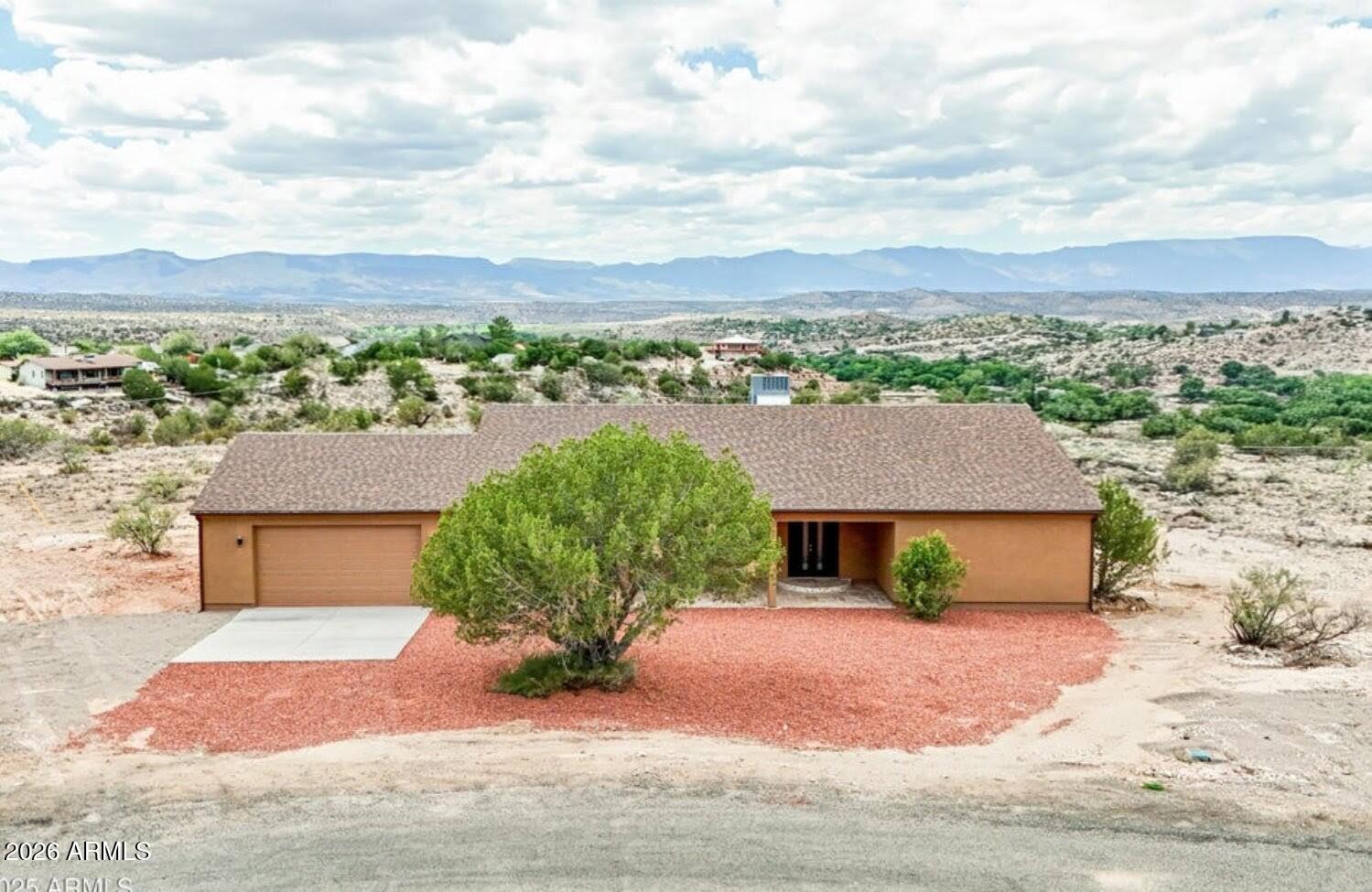 4695 Kerry Drive Rimrock, AZ 86335 - Photo 37 of 47 a front view of a house with a yard and garage