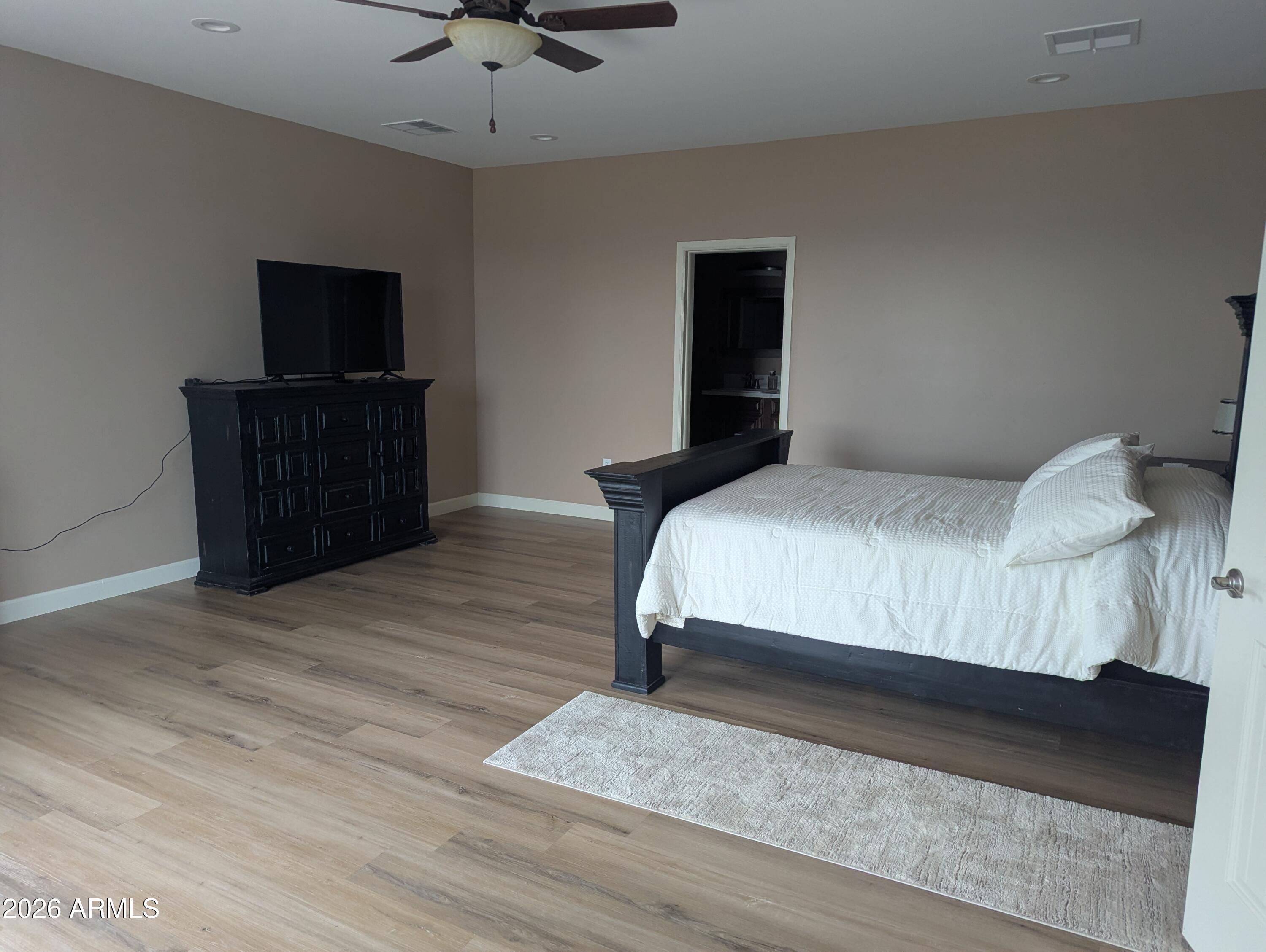 4695 Kerry Drive Rimrock, AZ 86335 - Photo 46 of 47 a bedroom with a bed and a flat screen tv