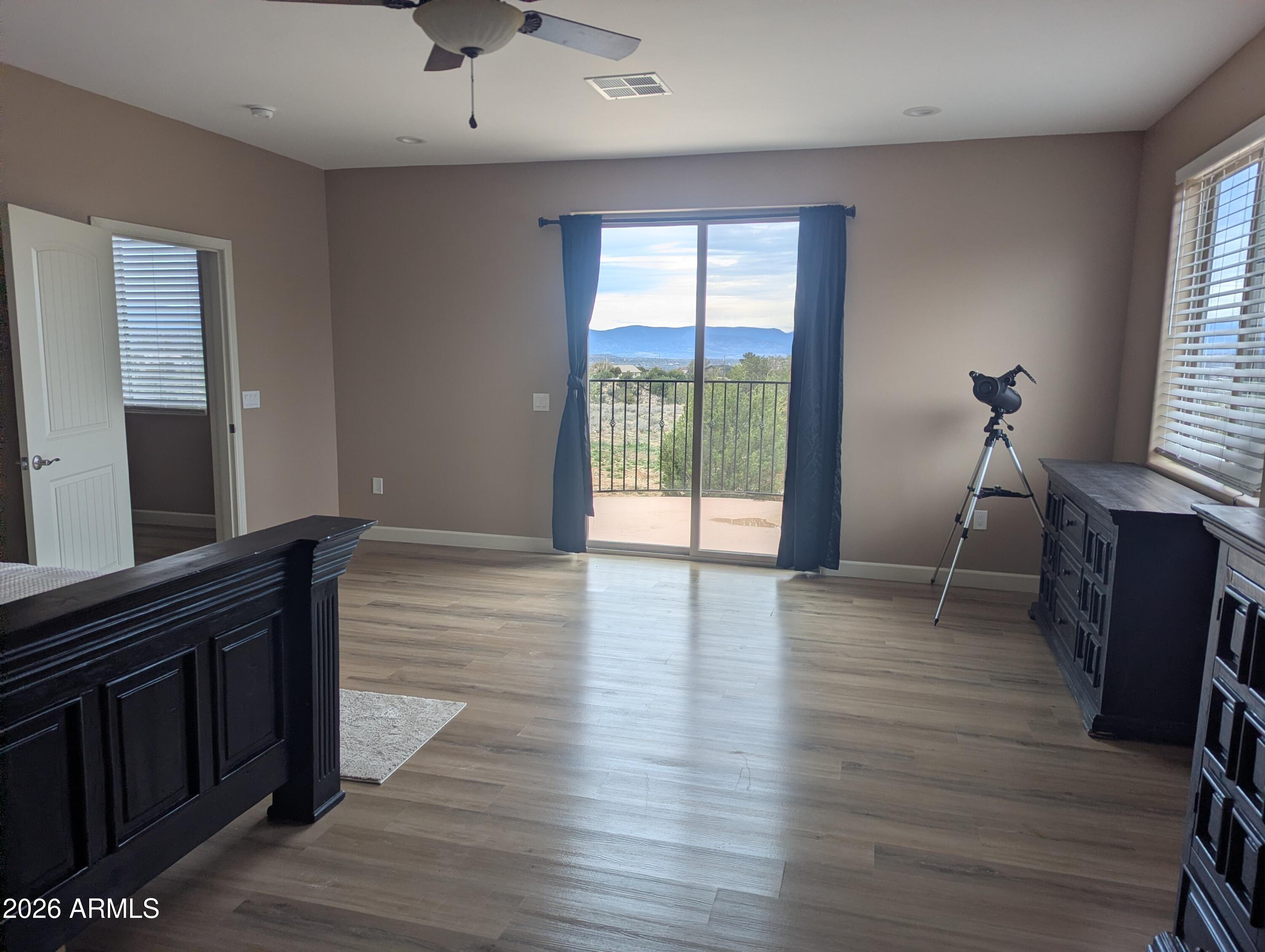 4695 Kerry Drive Rimrock, AZ 86335 - Photo 47 of 47 a view of an empty room with wooden floor and a window