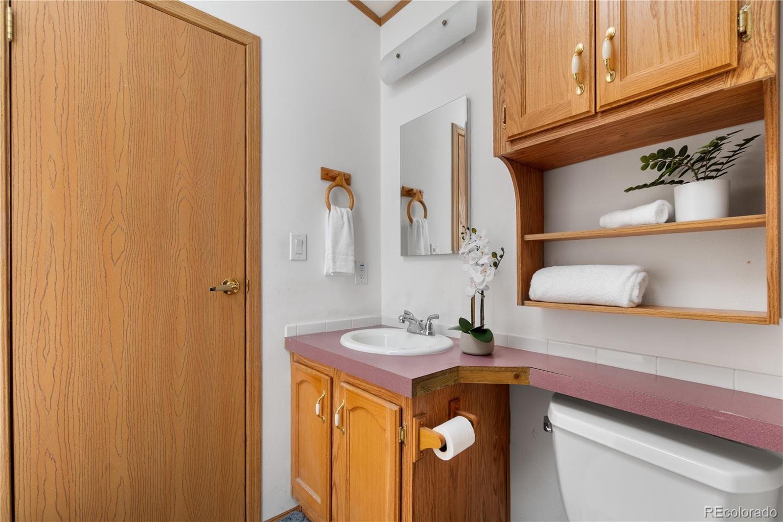 13201 Cavanaugh Road Hudson, CO 80642 - Photo 19 of 41 a bathroom with a sink and a mirror