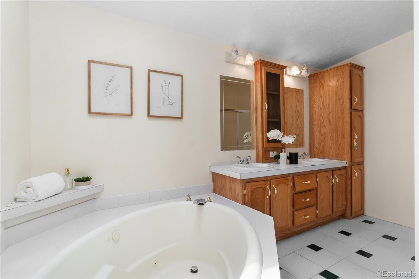 13201 Cavanaugh Road Hudson, CO 80642 - Photo 26 of 41 a bathroom with a tub sink and mirror